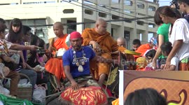 Monks receiving alms on elephant back