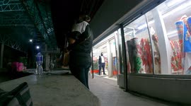 Time lapse of people shopping in downtown Hermosillo Mexico, at night walking among the lights of the city a few weeks before Christmas and New Years. Daily life