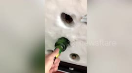Chinese resident takes advantage of freezing weather by storing beer in wall of snow