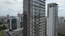 Workers on lift platform finishing finishing in building under construction in Vitória - Brazil