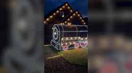 Father and son turn front hedge into incredible 'Polar Express' themed light display