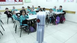 Palestinian students interact with a locally-made educational robot during a science class at a private school