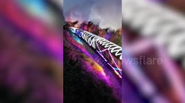 Watch this train covered in CHRISTMAS LIGHTS wind through UK village