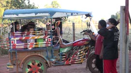 Local villagers and their kids take a trip in a sky lab on a small rural road in North East Thailand.