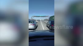Bizarre footage shows truck dragging car pinned underneath it down Illinois motorway