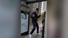 Excited Chinese man jumps in and out of residential community after COVID-19 lockdown lifted