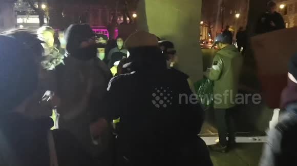Police inspector bundled by protesters before scuffles erupt