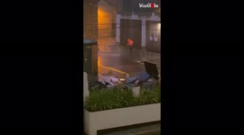 Hyper-efficient man caught washing sidewalk during heavy storm