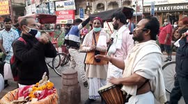 A Group of ISKON devotee playing with devotional song at a busy Street of Chandni Chowk in Delhi