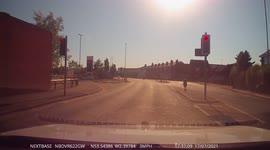 Cyclists rides towards traffic inbetween cars
