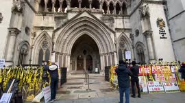 Supporters of Julian Assange decorates Royal Courts of Justice with placards as ruling expected in extradition case