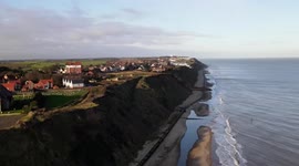 Seaside homes left dangling on cliff edge after huge landslide in Norfolk, UK