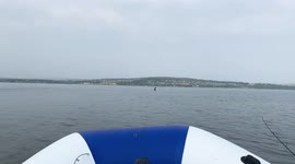 The guy walks in the middle of the Volga river