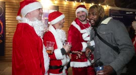 'I love you Santa!': Christmas cheers as man meets crowd of drinking Santas in London's Leicester Square
