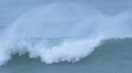 Rare giant waves draw surfers to Newquay in Cornwall, UK