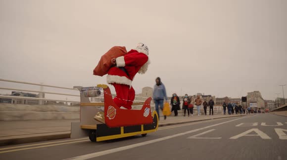 'Santa Cruise' drops presents off while riding electric sleigh through streets of London