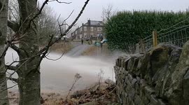 Villagers on the Penine Way in Littleborough shocked to see the force of an underground river has broken through the road spewing out a torrent of stones and water