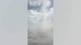 Dust devil tornado twists on dirt path in Philippines