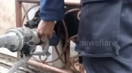Firefighters A Black Dog Pinched by an Iron Fence In Cilincing, North Jakarta Indonesia