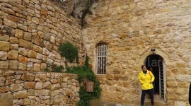 Palestinians walk amid cliffs during their journey in the village of Ein Arik near the West Bank city of Ramallah