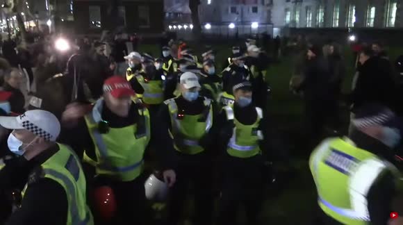 Police are forced to retreat as they lose control of the crowd during End Covid Restrictions Protest - London