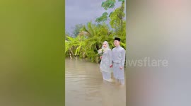 Couple carry on with wedding through floods in Malaysia