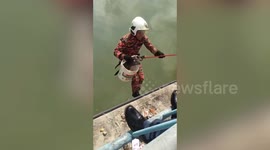 Heroic firefighter climbs down dirty canal to save trapped kitten