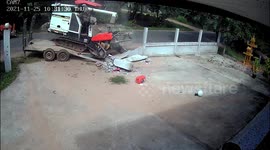 Harvester smashes truck into garden wall