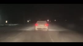 Minnesota driver notices funny looking face on the back of a car driving home Christmas day