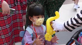 Children in Thailand having Christmas fun with balloons and swings at a shopping mall in Bangkok