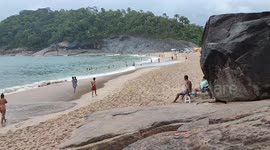 Visitors in the Сrying Сave, Ubatuba, Brazil