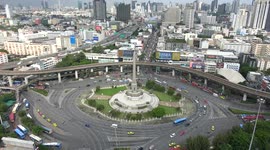 Vehicles travel around Victory Monument statue in Bangkok, Thailand