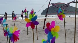 Children’s kites fly during windy weather on beach in southern Thailand