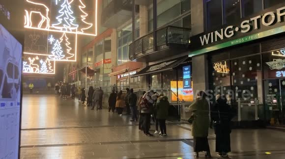 Shoppers queue around the block as Next opens for its Boxing day sale ...