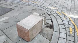 A Broken Street Bollard After Colliding With A Vehicle Lays Unrepaired