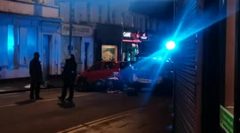 A car crush with a deliver man on a motorbike