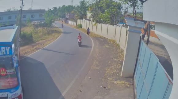 Indian scooter rider has TWO near-misses with bus and tree