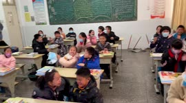 Boy remain calm while other students cheer as teacher announces exams cancelled due to COVID-19