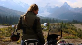 Girl travels Canadian rockies with her small dog in a sidecar on a motorcycle