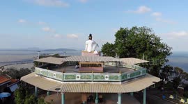 Visitors enjoy spectacular views from Buddhist shrine overlooking Gulf of Thailand sea
