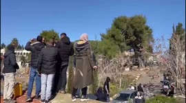 Palestinians take to the roof of a home, threatening to blow up the dwelling with a gas balloon after Israeli police arrive to carry out an eviction order