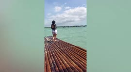 Woman hilariously slips on platform during beach photoshoot fail with friends