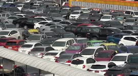 Crazy car park is so packed drivers have to push their motors by HAND like giant game of Tetris