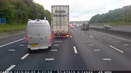Dangerous driver M25. Luxury day-van almost gets obliterated by pulling in between two trucks as they brake hard