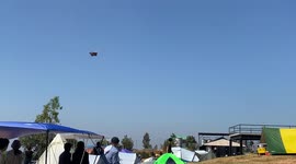 Stunned tourists watch as strong winds sweep camper's tent away
