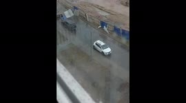 Fence flies into cars, almost hits woman during a storm in Minsk, Belarus