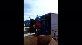 Getting a 40 ft. boom-lift/cherry-picker out of a shipping container. You can do it laying down! (You have to...)