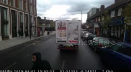 Cyclist almost goes under wheels of truck in heavy traffic, North Acton, London, UK