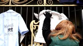 Nurse's hang NHS uniforms on gates of Manchester Mayor Andy Burnham's office