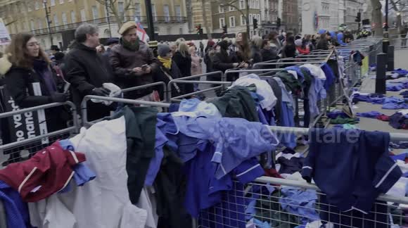 NHS staff leave their scrubs at Downing Street in protest against mandatory COVID vaccines